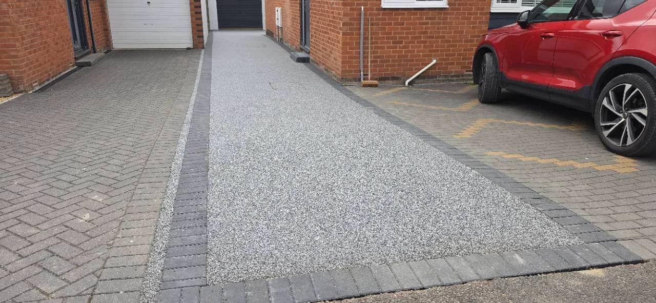 After photo of a New Palazzo resin bound driveway with charcoal block borders in Exminster installed by Quantock Paving