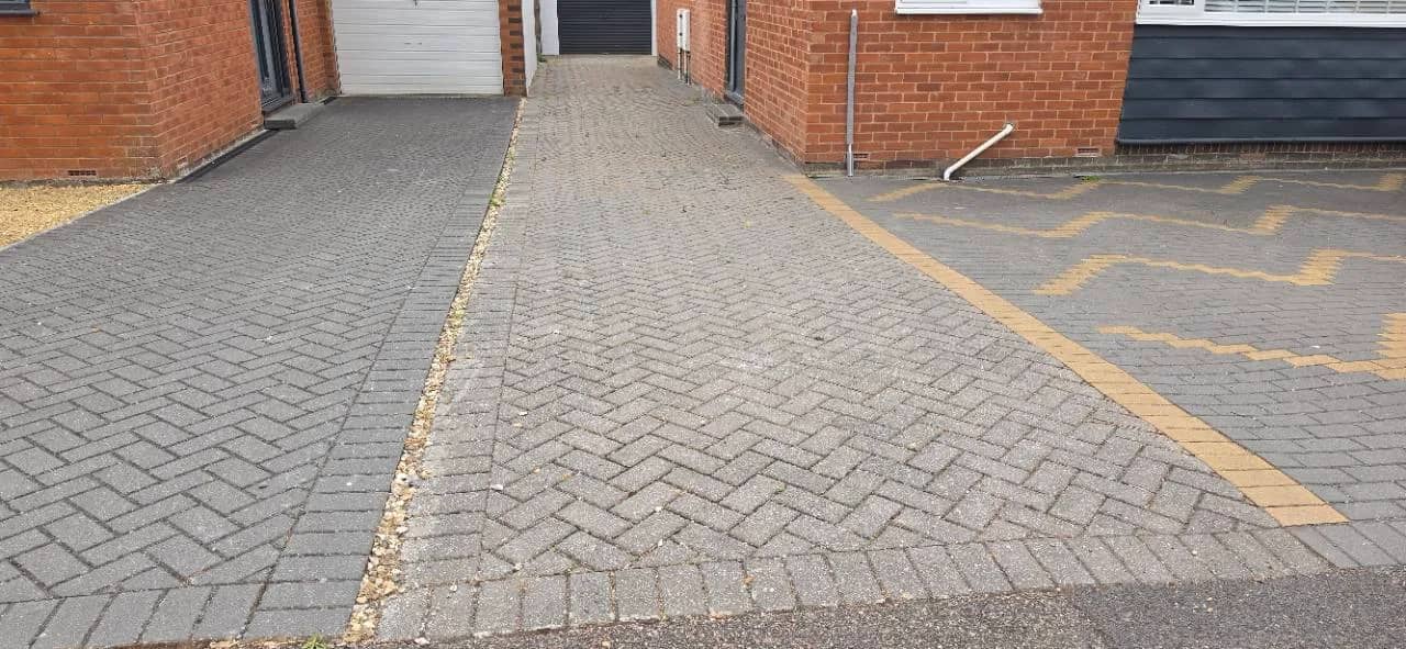 Before photo of an Exminster block paved driveway before a New Palazzo resin bound driveway installation with charcoal block borders