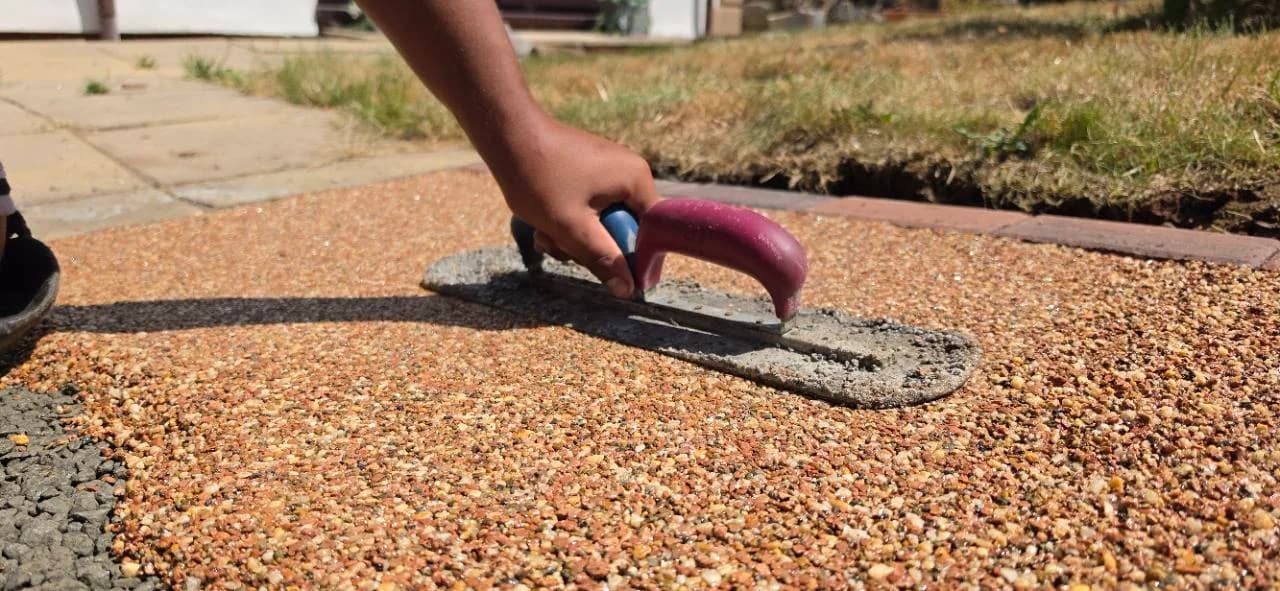 Canyon Stone resin bound aggregate being hand trowelled on a driveway in Highbridge