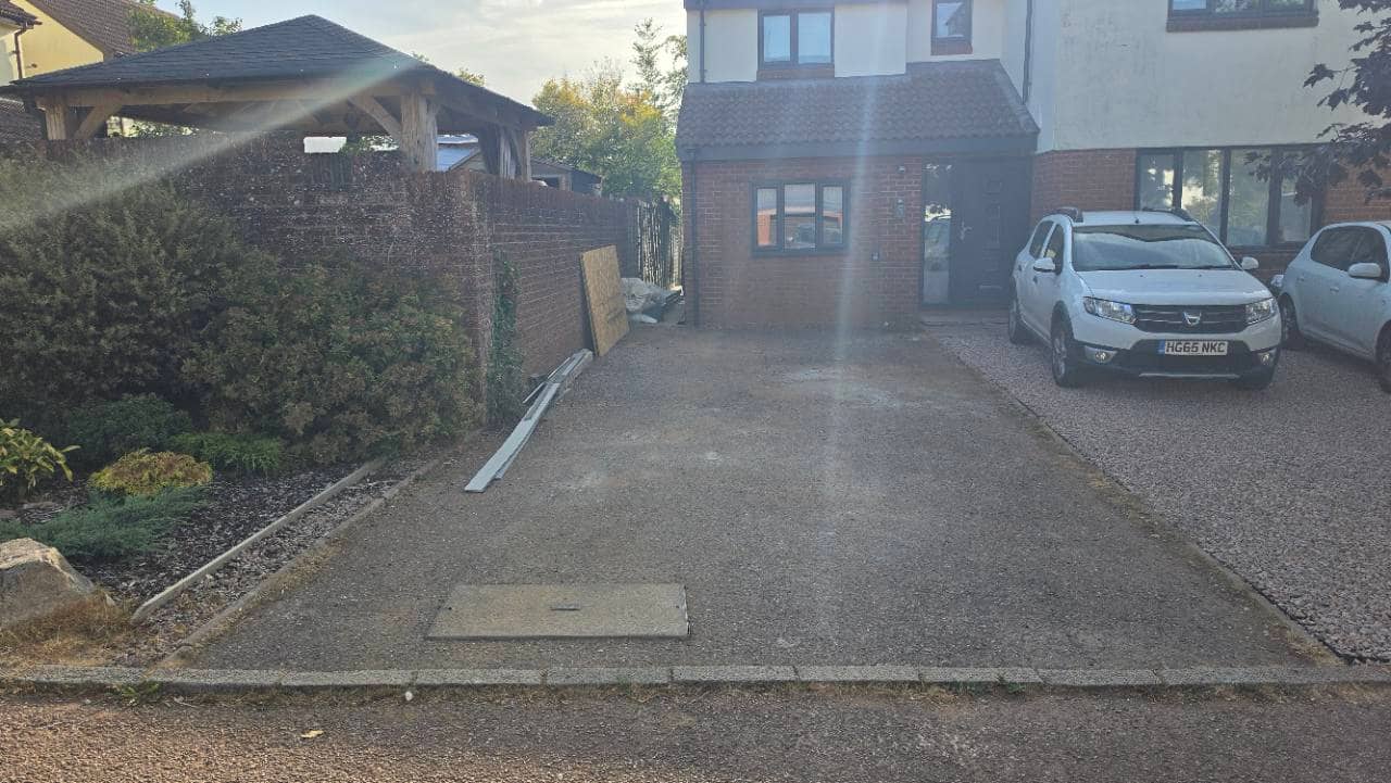 Before photo of a worn concrete driveway in Tiverton before New Palazzo resin bound surfacing