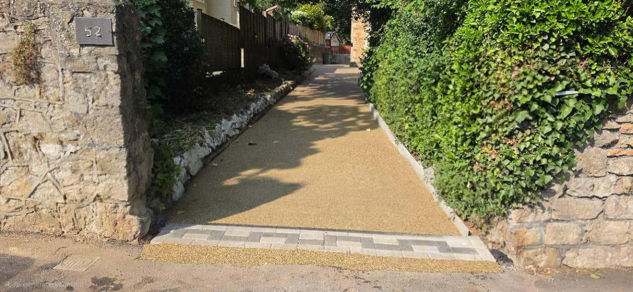 After photo of a completed Canberra resin bound driveway with block paving threshold in Weston-super-Mare