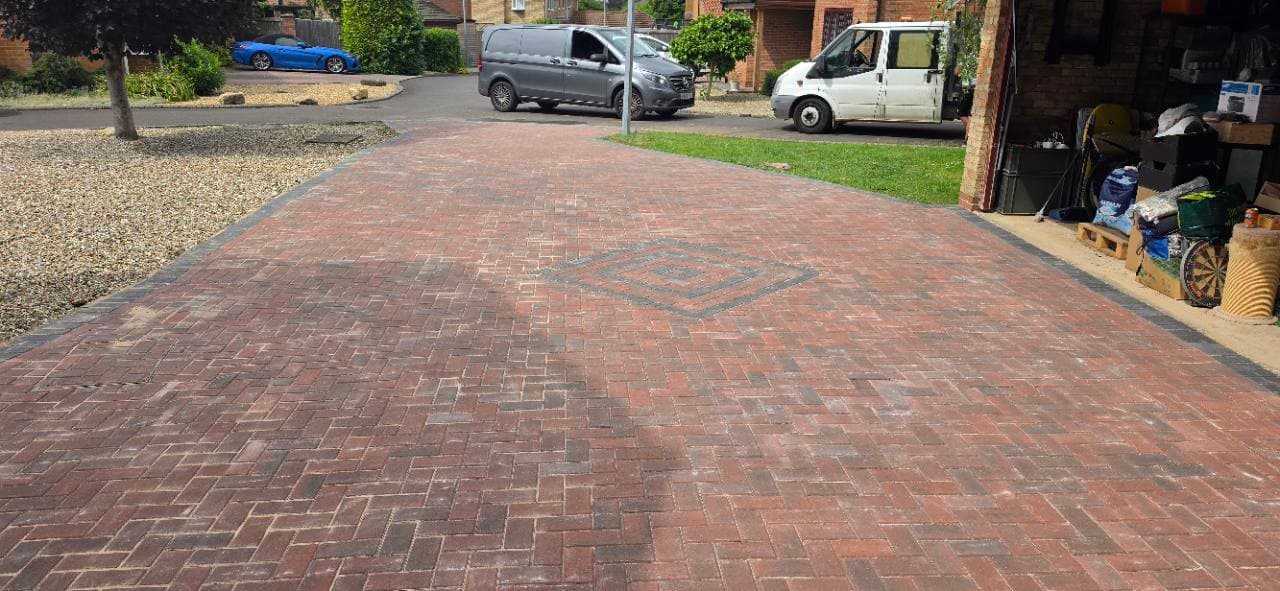 Central diamond pattern and recessed manhole cover in Bristol block paving driveway