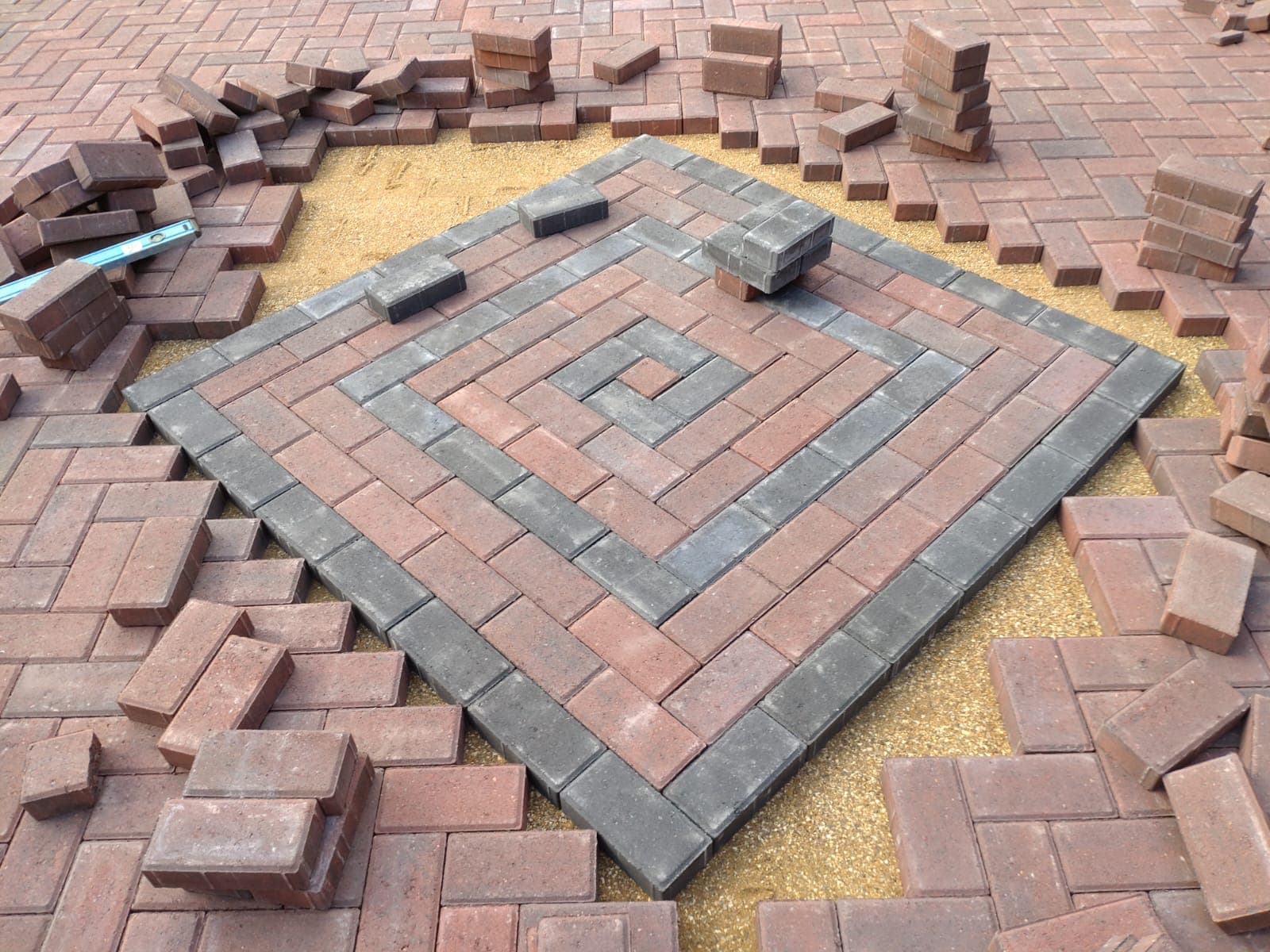 Charcoal central diamond detail being laid during a Bristol block paving driveway installation