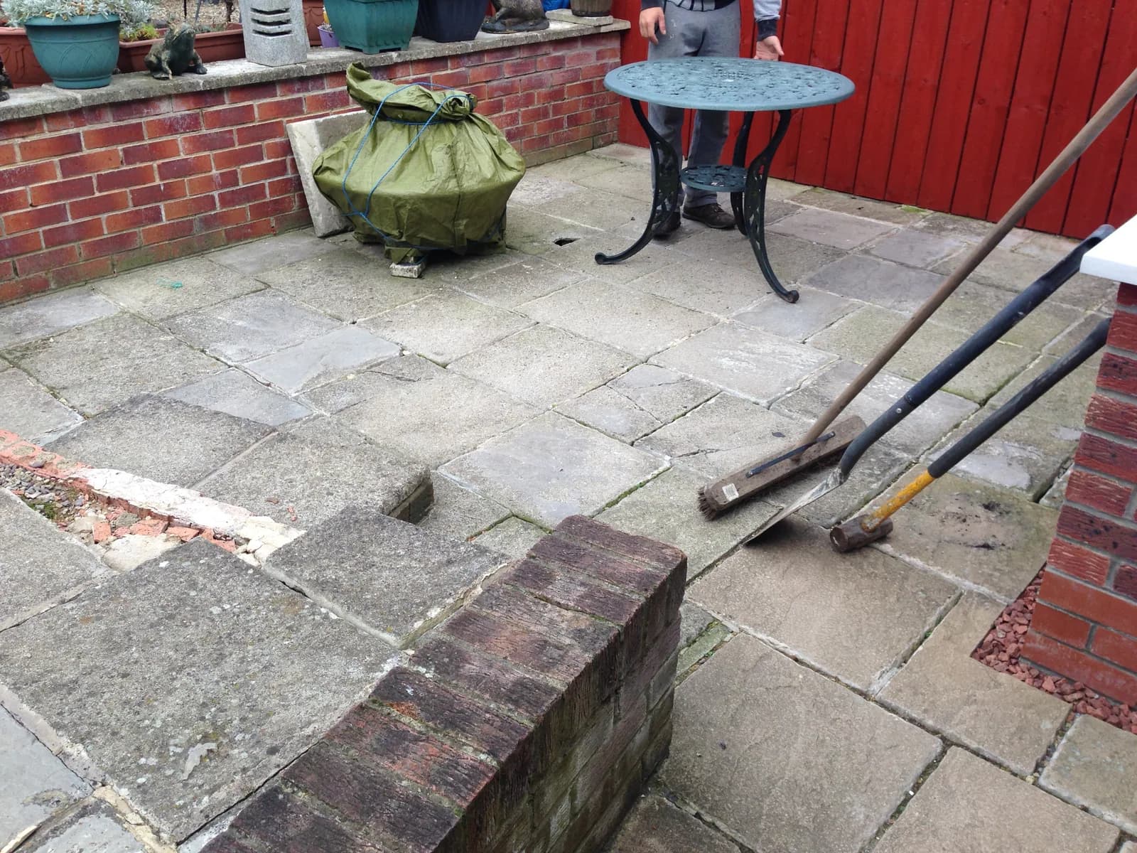 Old uneven slab patio before block paving work started in Burnham-on-Sea