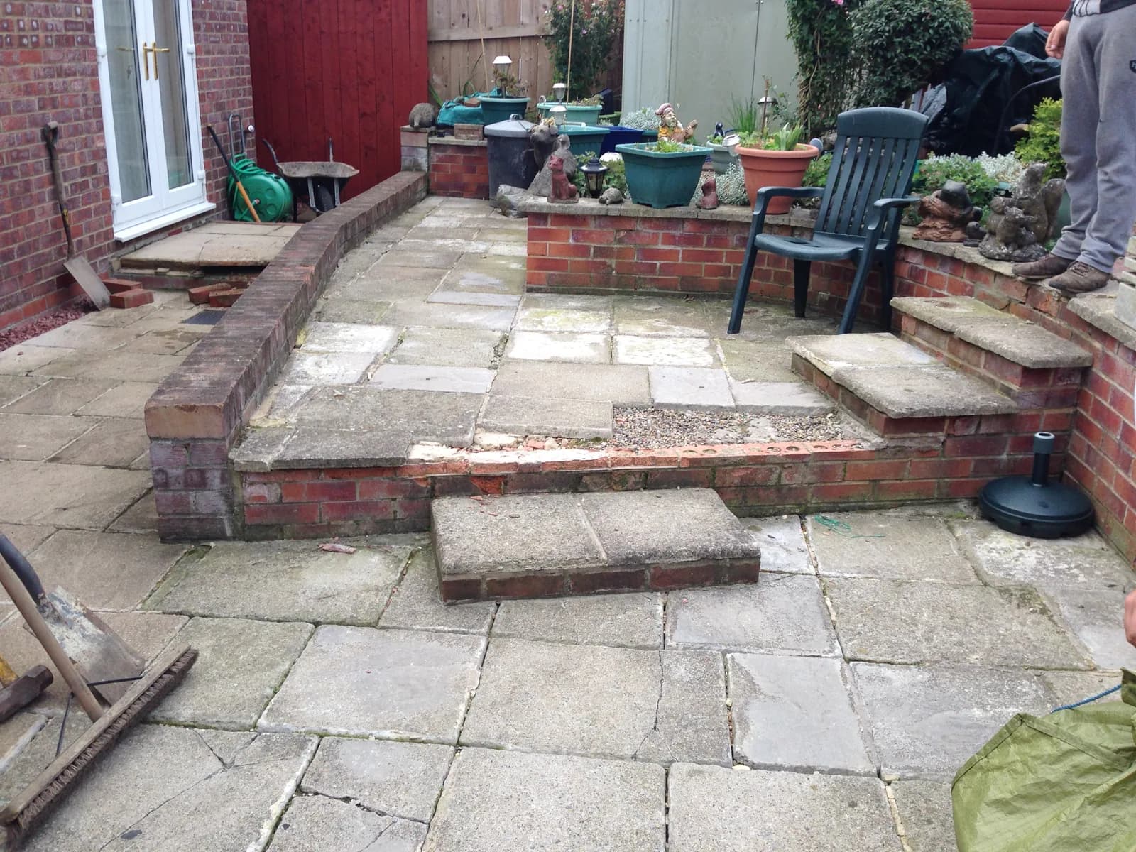 Wide view of the old uneven patio before block paving installation in Burnham-on-Sea