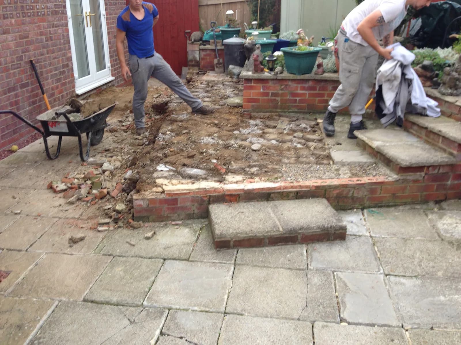 Old patio slabs being lifted during preparation in Burnham-on-Sea