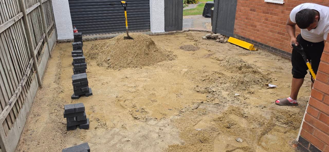 Block paving border installation under way near the garage approach in Exminster