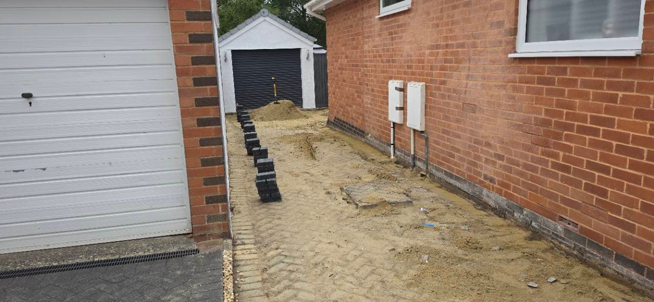 Block paving border materials lined up along the side run in Exminster