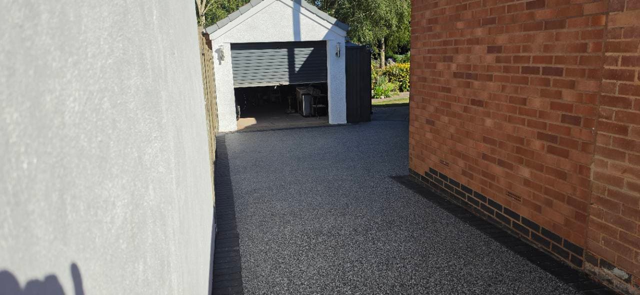 Palazzo resin bound side access surfaced through to the garage in Exminster