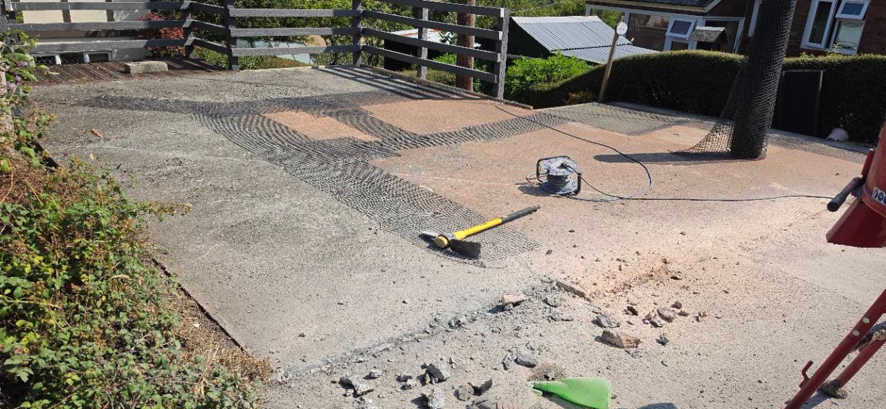 Reinforcement mesh installed over an existing concrete driveway in Exeter before a resin overlay