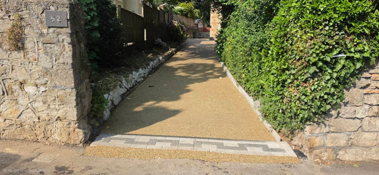 Completed resin driveway entrance with block paving threshold in Weston-super-Mare