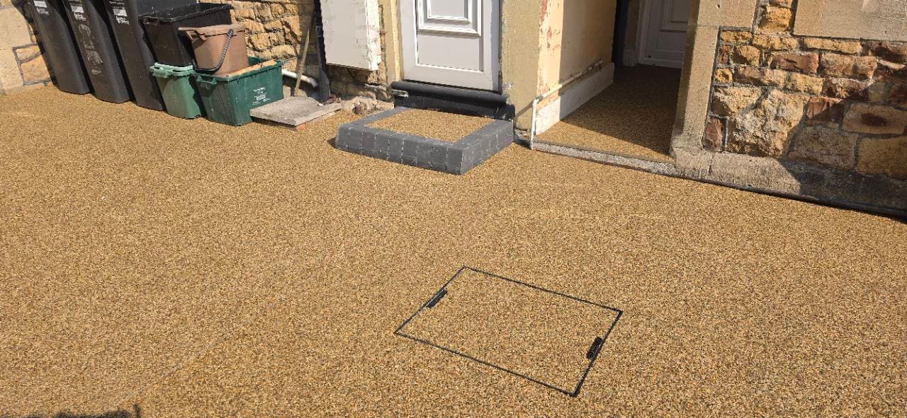 Canberra resin finish around a recessed cover and entrance thresholds