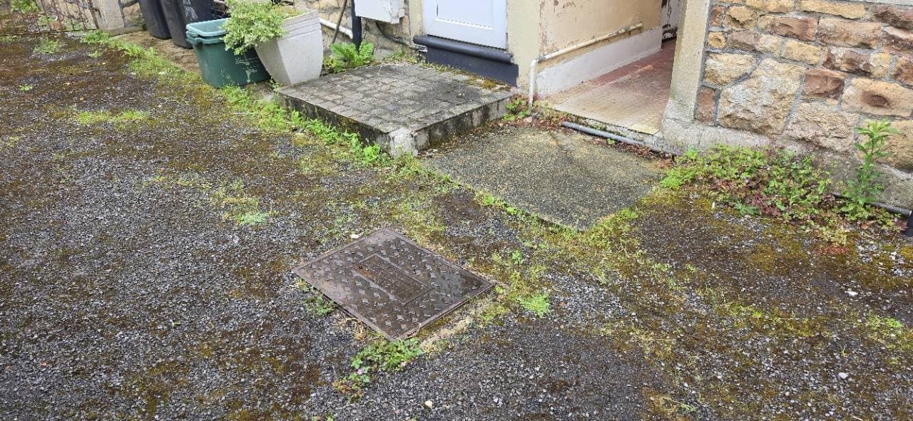 Existing tarmac and concrete around covers and door thresholds in Weston-super-Mare