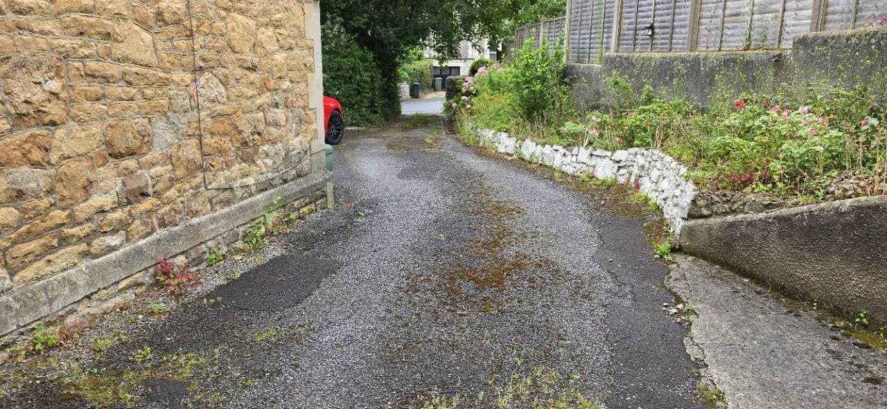 Side driveway with tired tarmac and concrete before resin bound prep