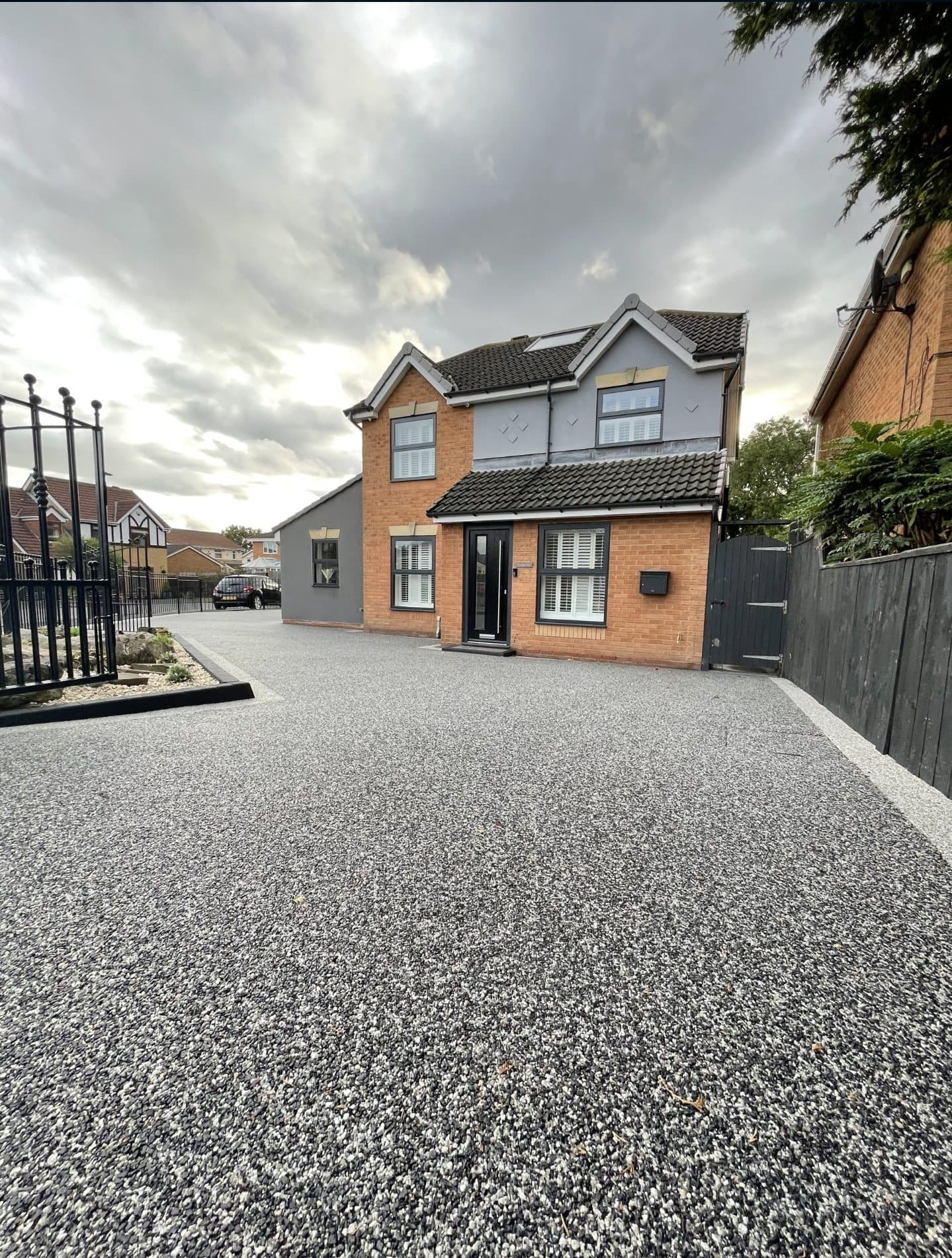 Silver-grey resin driveway on a gated frontage