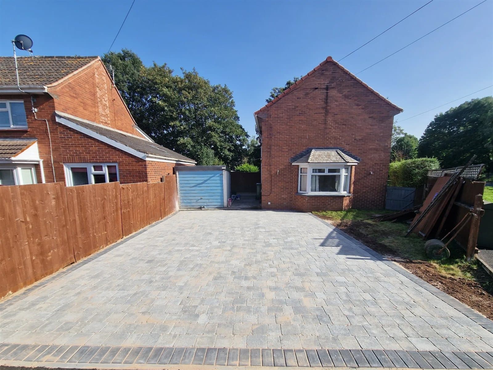 Silver-grey block paving driveway with charcoal edging