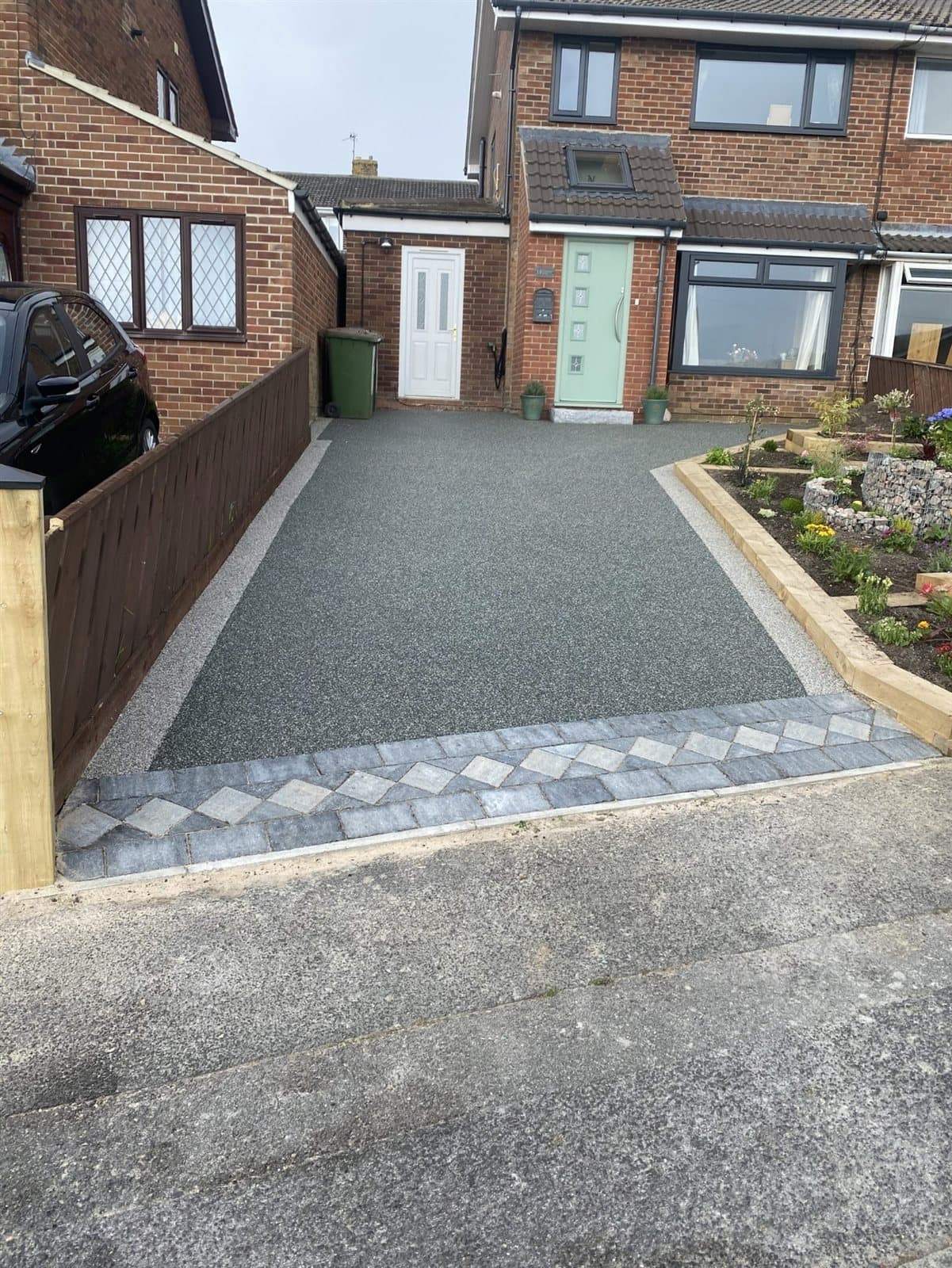 Grey resin bound driveway with diamond block paved entrance