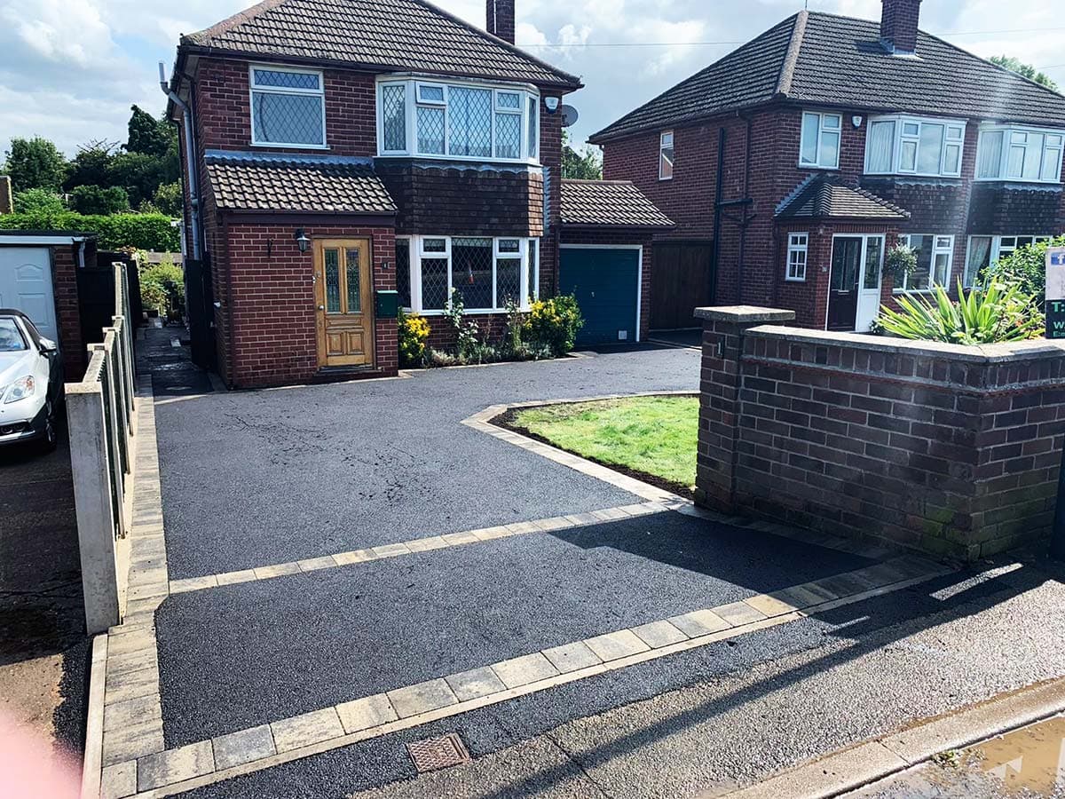 Tarmac driveway with block paved borders and lawn feature