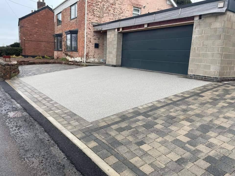 Silver resin bound driveway framed with block paving