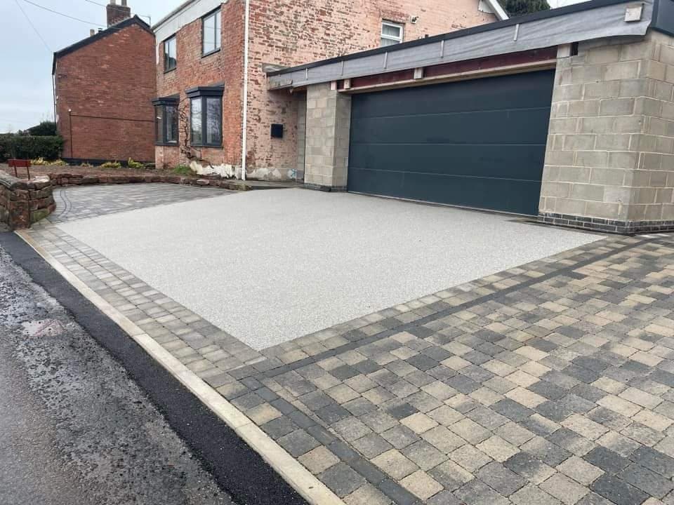 Silver resin bound driveway framed with block paving