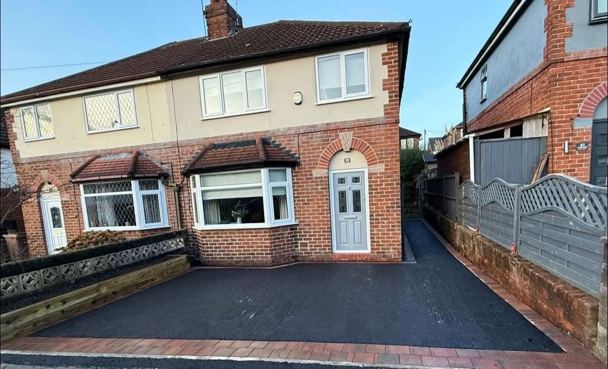 Tarmac driveway with brick-edged border to a semi-detached home