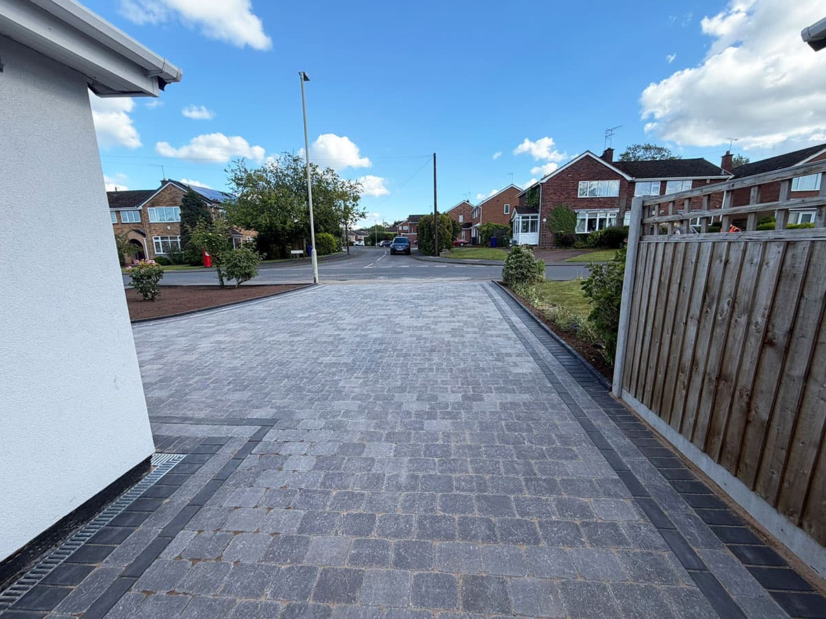 Grey block paved driveway with charcoal feature borders