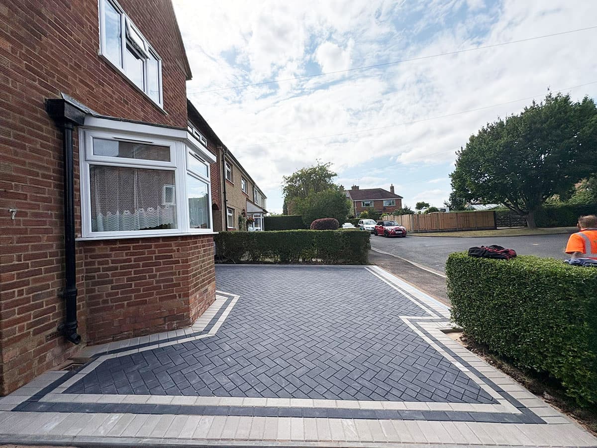 Charcoal block paving with crisp white border detail