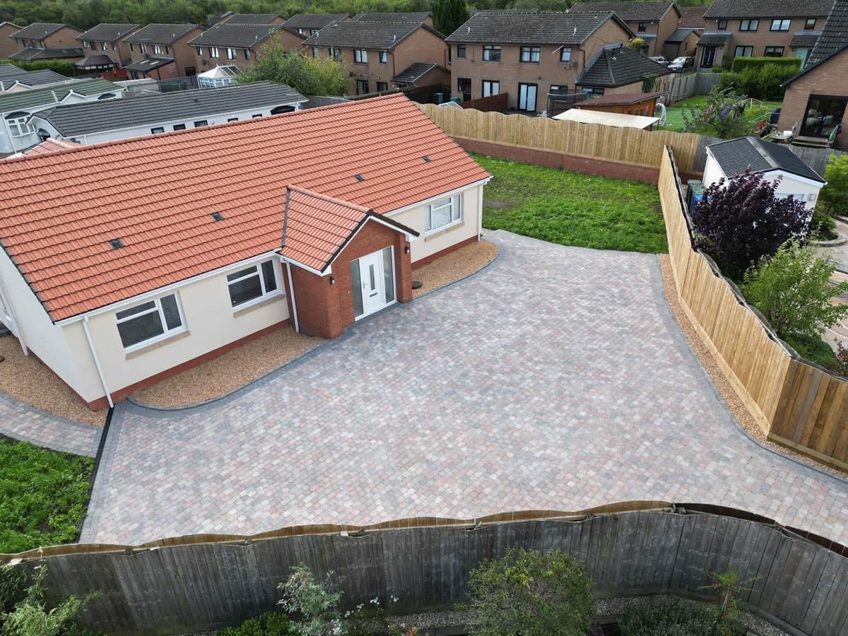 Rustic block paved driveway to a bungalow - aerial view
